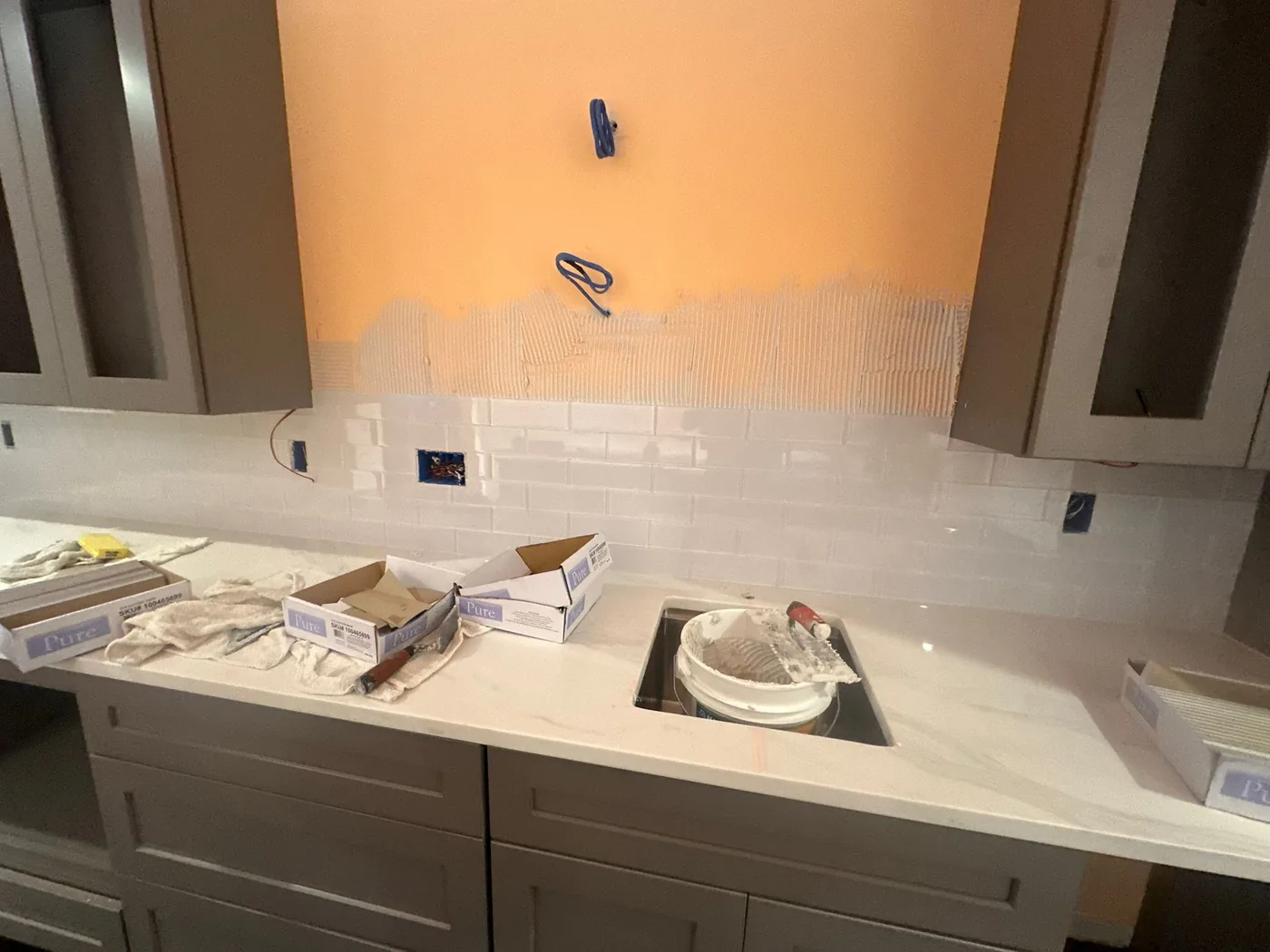 Backsplash installation during a basement finishing project in Johns Creek, GA