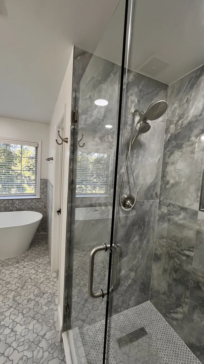 Finished glass shower with marble-look tile in Milton bathroom remodel