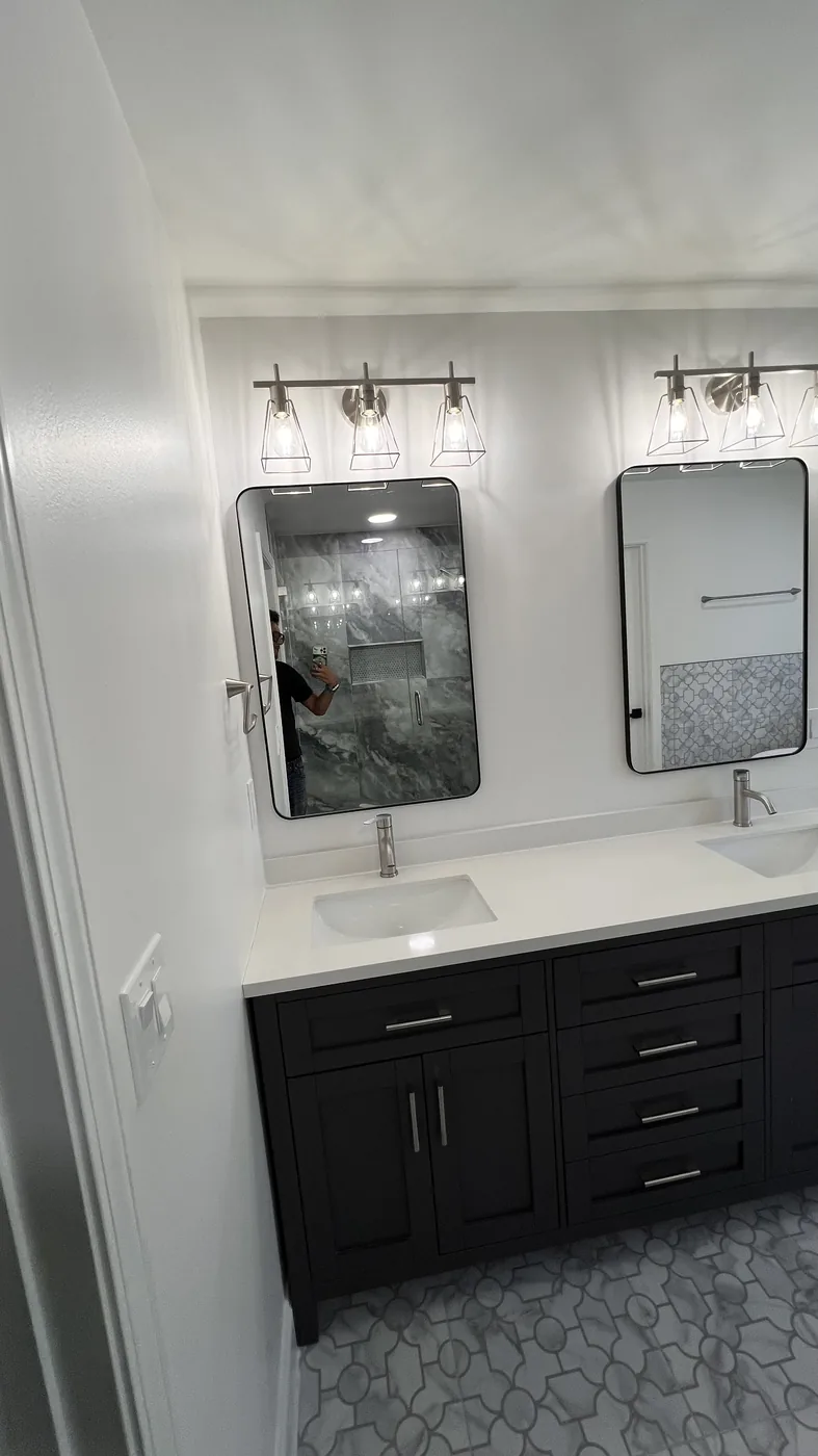 Finished double vanity with black cabinetry in Milton bathroom remodel