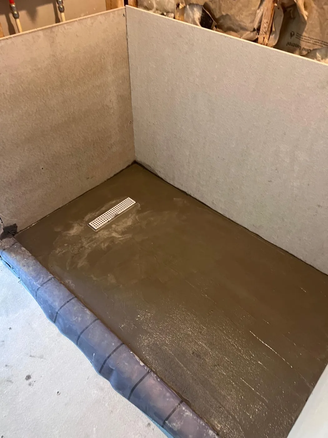 Custom shower base under construction during Milton bathroom remodel