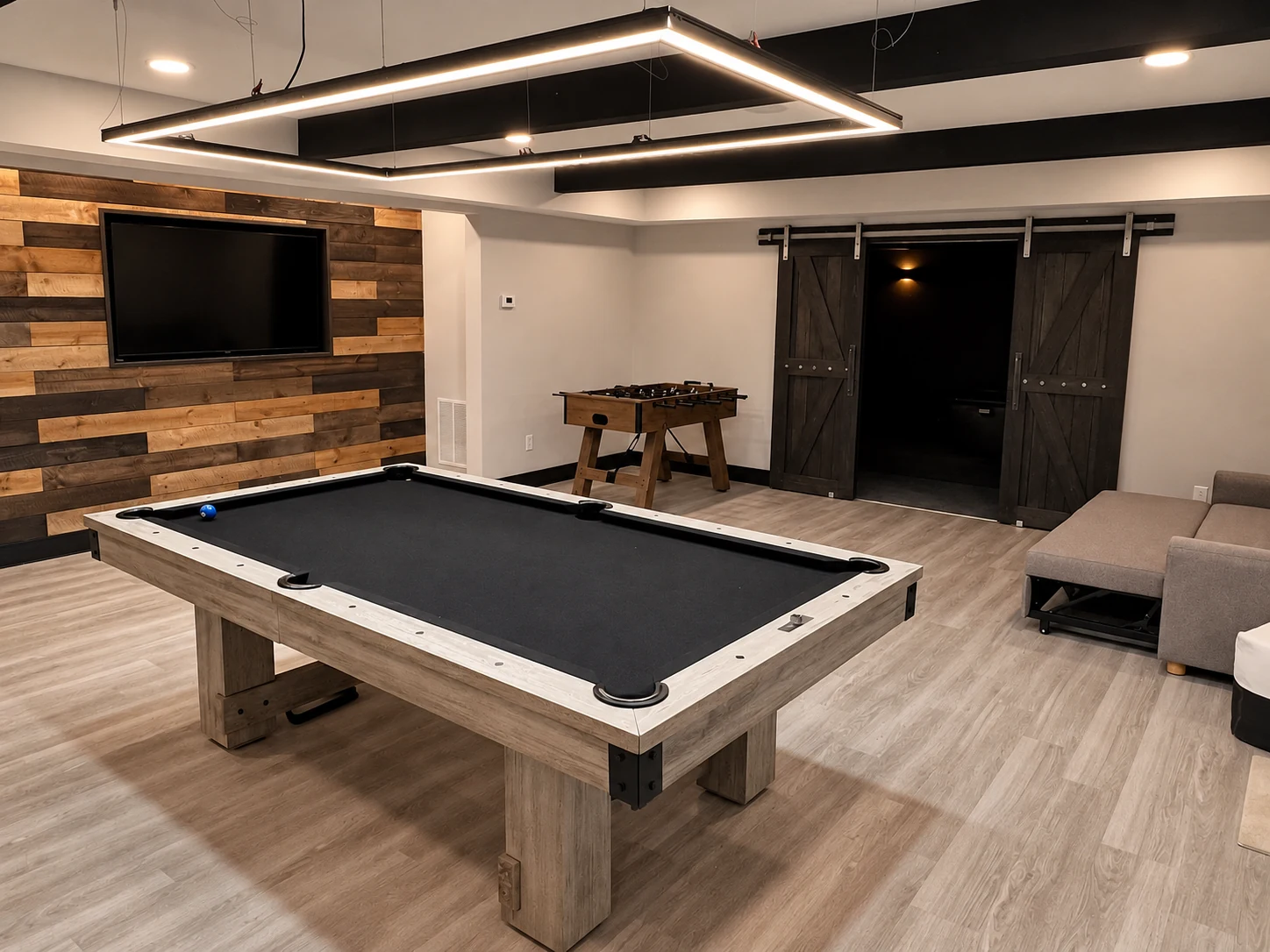 Finished basement recreation room with pool table and feature wall