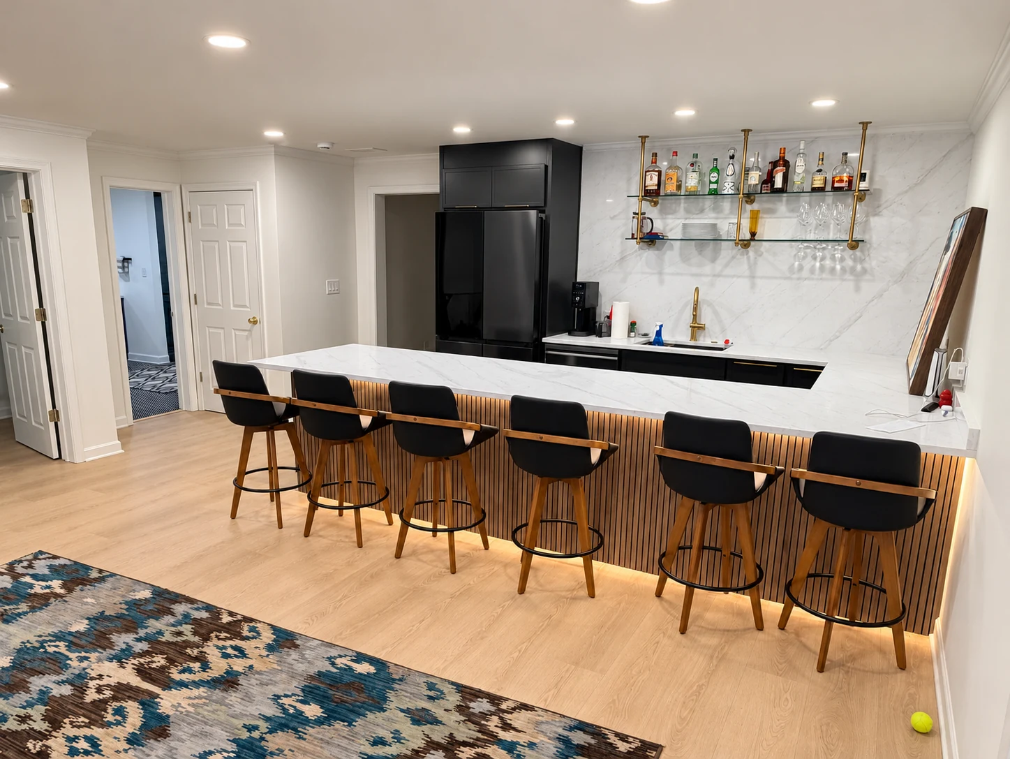 Finished basement with custom bar, cabinetry and entertainment area