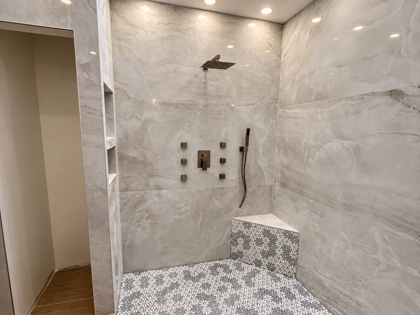 Completed walk-in shower with marble-look tile and modern fixtures