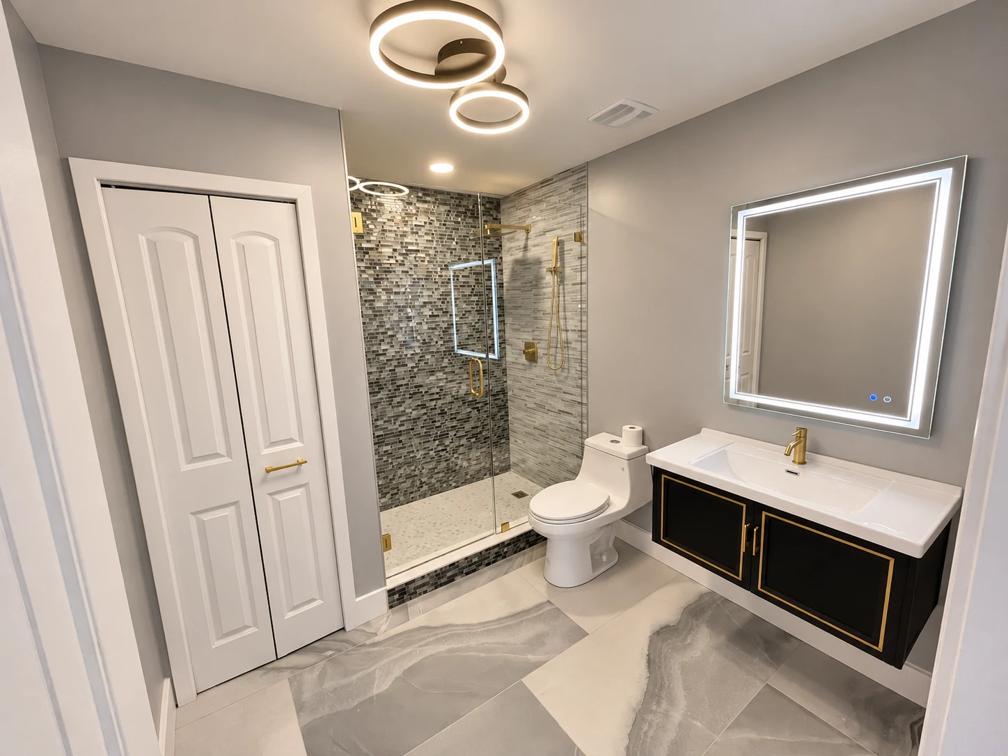 Completed bathroom renovation with glass shower and custom vanity