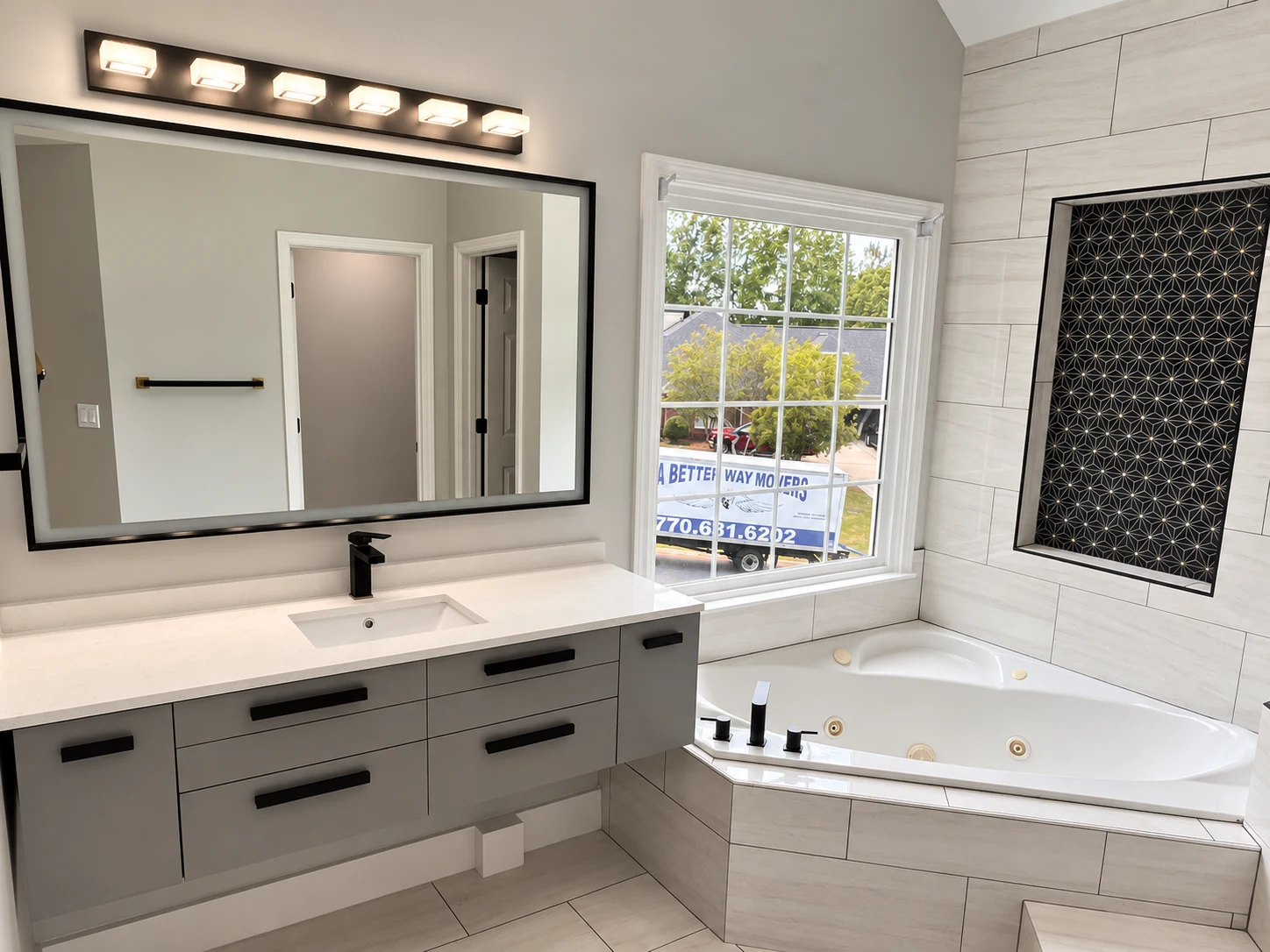 Bright primary bathroom with double vanity and soaking tub
