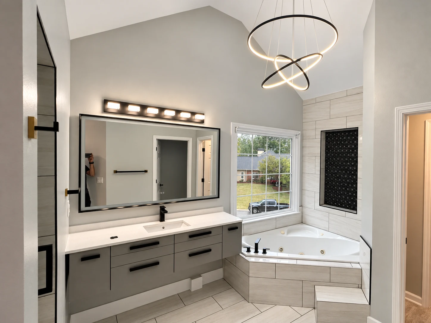 Modern bathroom remodel with double vanity and decorative lighting